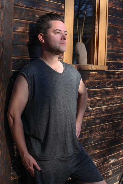 Man outside of sauna wearing a merino wool sleeveless top