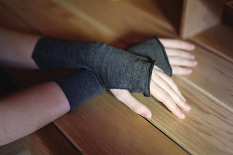 Close up of merino wool fingerless gloves on woman