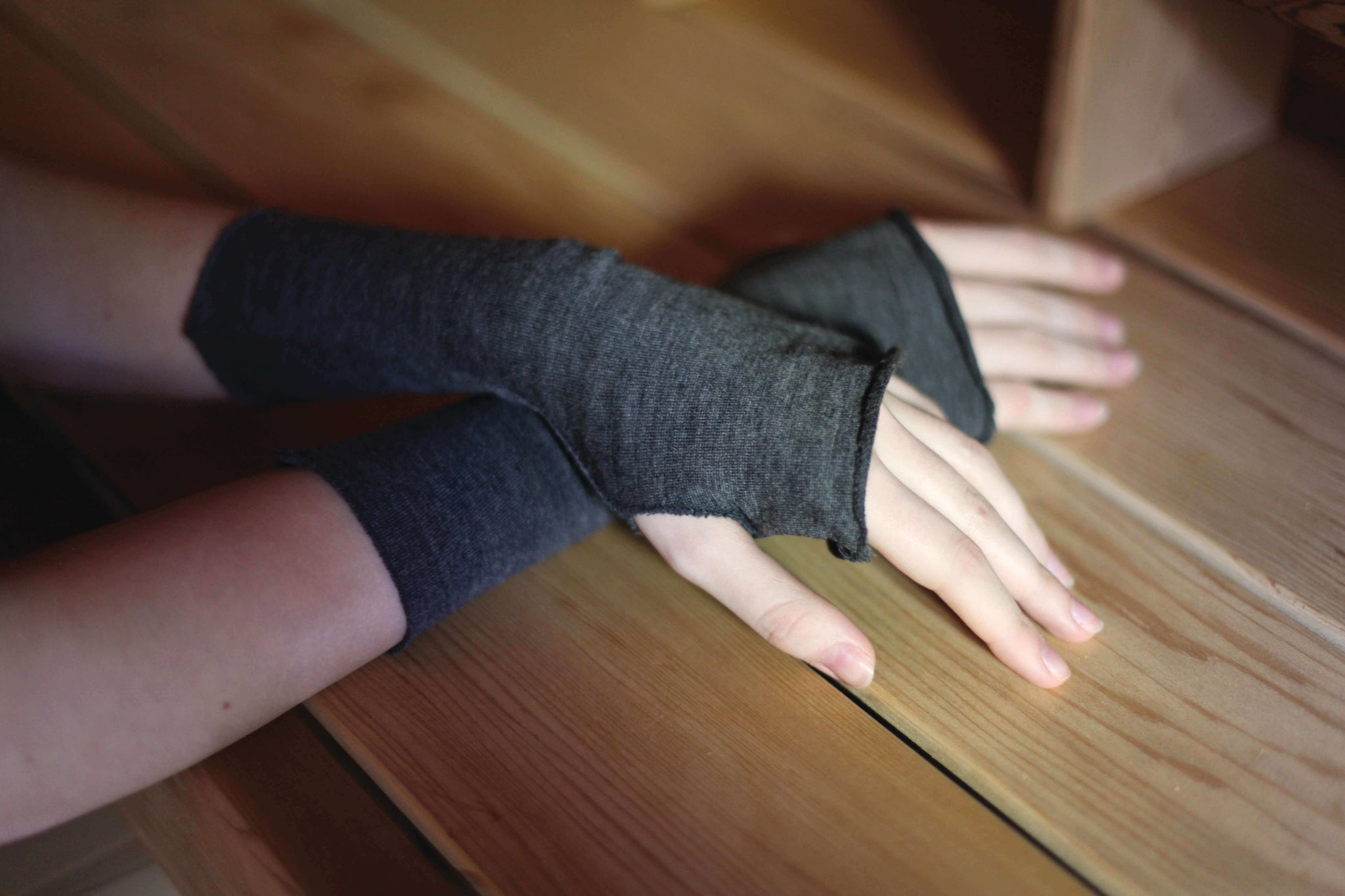Close up of merino wool fingerless gloves on woman